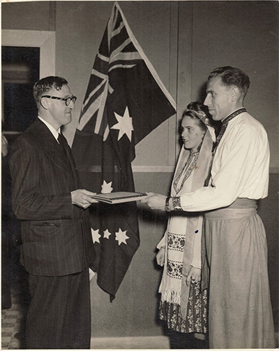 Bonegilla, 1949 During Australia’s Minister of Immigration, Arthur Calwell’s visit to Bonegilla’s Migrant Camp, Claude Brilinsky and Olha Zahorodnyj present him with a gift.   Courtesy of Daria Zahorodnyj